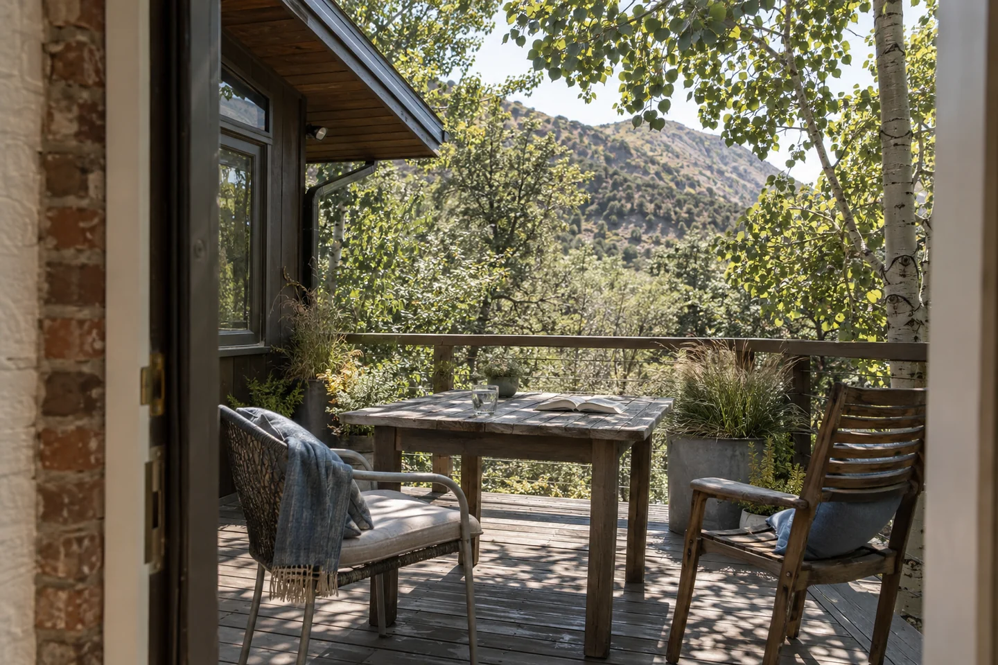 AI-generated shaded home terrace with weathered chairs, a book and wooded foothills beyond